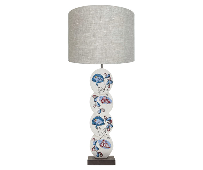 Using Kit's signature fabric design as inspirations the Psycho Sprig lamp, is hand painted by Melissa White , with its floral design of paisley like foliage curly up the 4 discs in shades of blue and pink, on an off white back ground.