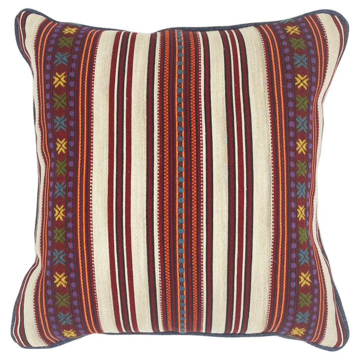 The Romany Weave Cushion has alternating stripe panels in deep reds, orange, navy and ecru, overstitched in delicate embroidered double crosses, in yellow, purple and green, with contrasting blue piping.