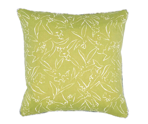 Lime green 45x45cm cushion, with simplified floral designs outlined in white, edged in white piping