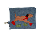 A playful Running Labrador pouch, with hand applique and embroidery. Ready for rainy weather the dog's bright red boots and matching scarf are detailed in flowing chain stitches, with running stitch and satin stitches highlighting its eyes, nose and mouth. A basket weave tweed fabric, in tones of rich denim, ember and green.