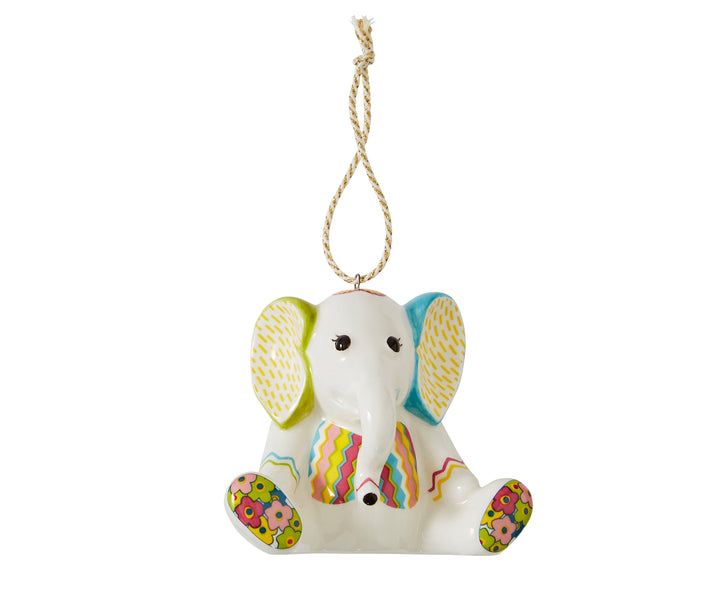 The Jambo seated Elephant white china ornament is inspired by Kit Kemp's patchwork toys and is decorated in bright pastel shades, and patterns, with floral soles of his feet, to zig zag striped waistcoat and green and turquoise ears.