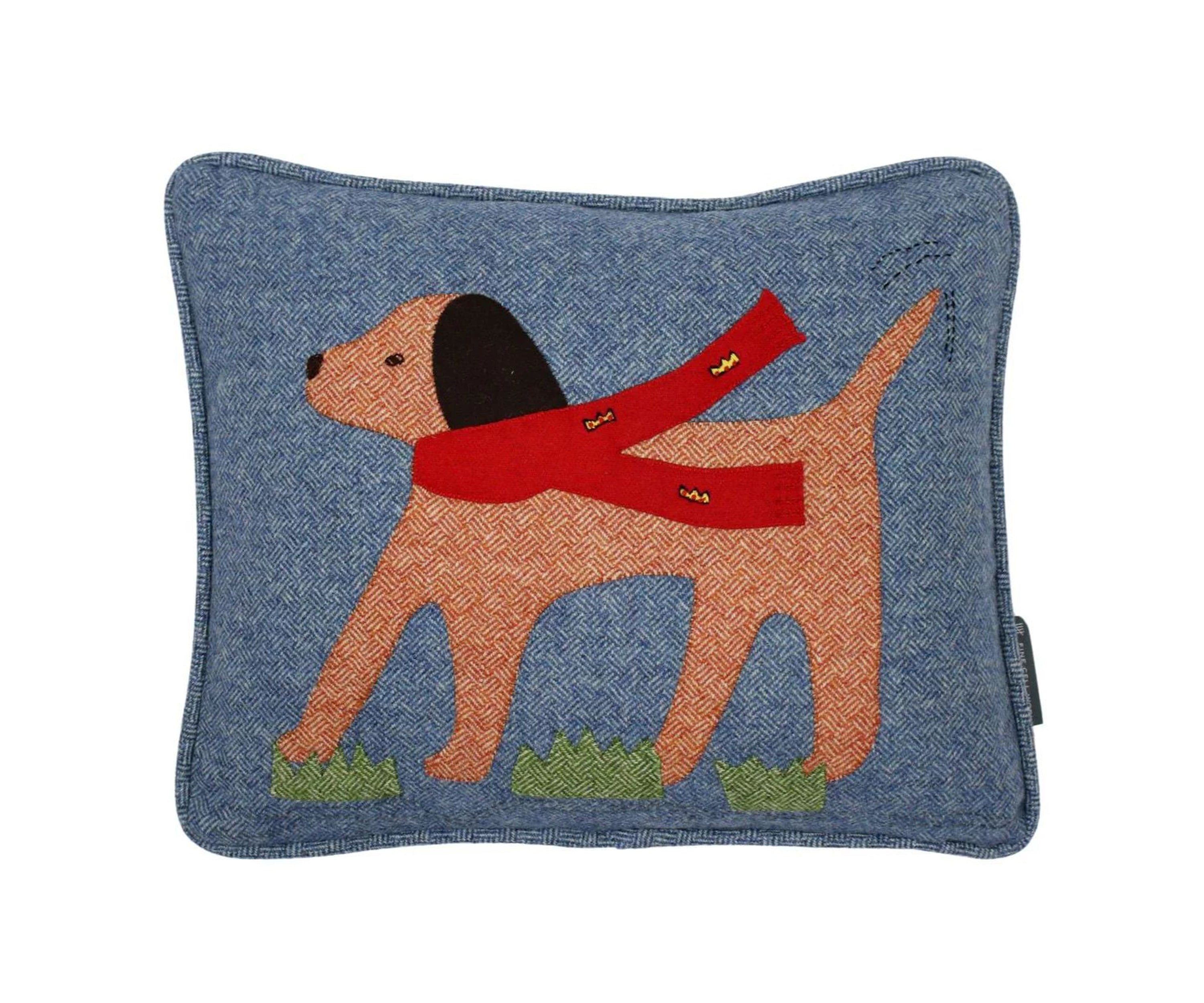 Labrador Cushion, hand applique and embroidery. The dog's flowing felt scarf is embroidered with red and yellow crowns in satin stitch, with running stitch and satin stitches highlighting its eyes, nose and mouth. In a basket weave tweed fabric, in tones of rich denim, ember and green with a denim blue basket weave reverse and matching piping, each perfectly plump cushion comes with a feather filler with a zip fastening. 