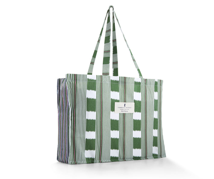 Our Bag for life is a large cotton bag, printed with Kit's Lost and found chequerboard print in green and white, with pink ticking detailing , combined with the variegated stripes of Peace and love, in blue, green, white and pink, in the side gussets.