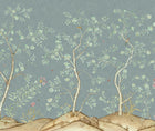 Kit's New Songbird Wallpaper, in collaboration with Andrew Martin, takes the stylised nature of Chinoiseries landscapes to a softer and more relaxed realm with an English twist. The Rain colourway is suffused in the blue/ green of an English rainy day, where a breeze ruffles the leaves of loosely painted trees dotted with dog roses. From the delicate branches, songbirds call to each other across this serene panorama.