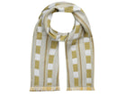 A long scarf in lemon and off white in a check/stripe style pattern produced using Kit Kemp's Lost and found fabric for Christopher Farr Cloth. Yellow and cream lines are interrupted by alternating boxes and dotted red and white lines.