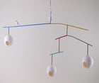 The Rocking Robin large suspended ceiling lamp, with a minimum drop of 0.97m. features three suspended eggs, counter balanced on a branch-like frame, softened with coloured, and monochrome twine, with a beautifully crafted funky robin, standing proudly between the nest-like eggs, in white, with a natural twine finished branch.