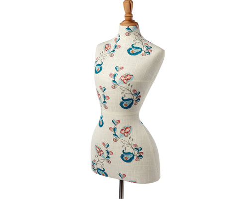 Front side view of mannequin with Psycho Sprig, Tropical Blue fabric. The design shows vibrant turquoise, pink and red curled vines