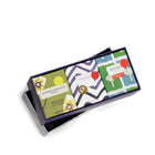 A box of three scented mini candles in gardenia sandalwood, lavender eucalyptus and wheatgrass bay. Each candle is boxed individually and then presented in an elongated blue box with a lid featuring cobalt cross design.