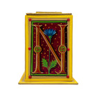 This bright yellow and red alphabet box is decorated with a gold letter N in a heraldic decorative style, with a blue floral motif and embellished with a pink and red jewelled lid. 