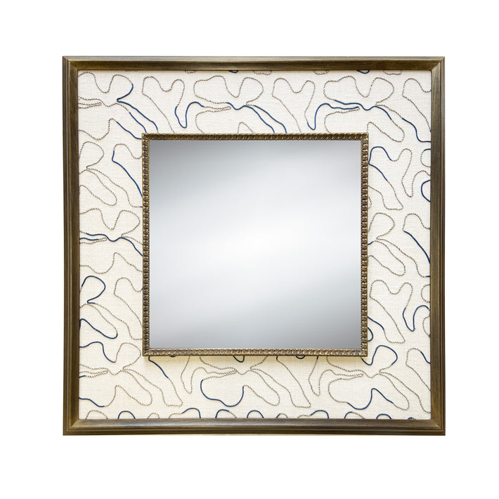 The Squiggle Mirror, features natural and blue cords stitched in looping curves to loosely form floral shapes, on a base of natural linen, stretched to form a wide decorative border around a square central mirror, in a wooden frame.