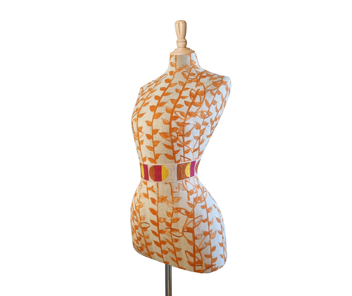 Side view of Mannequin with Kit Kemp's Orange Tea Leaf fabric for Christopher Farr with a Caravanne waist band