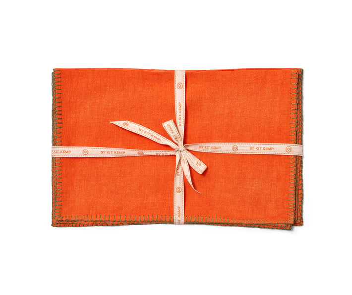 Beautifully soft Italian linen 35x45 placemats, orange linen hand-stitched in olive green blanket-stitching around the edges, sold in packs of 6, tied with a ribbon