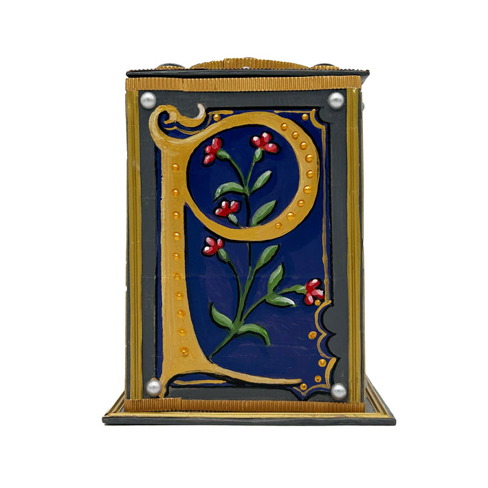 This blue and grey alphabet box is decorated with a purple letter P in a heraldic decorative style, with a red floral motif and embellished with a blue and grey jewelled lid. 