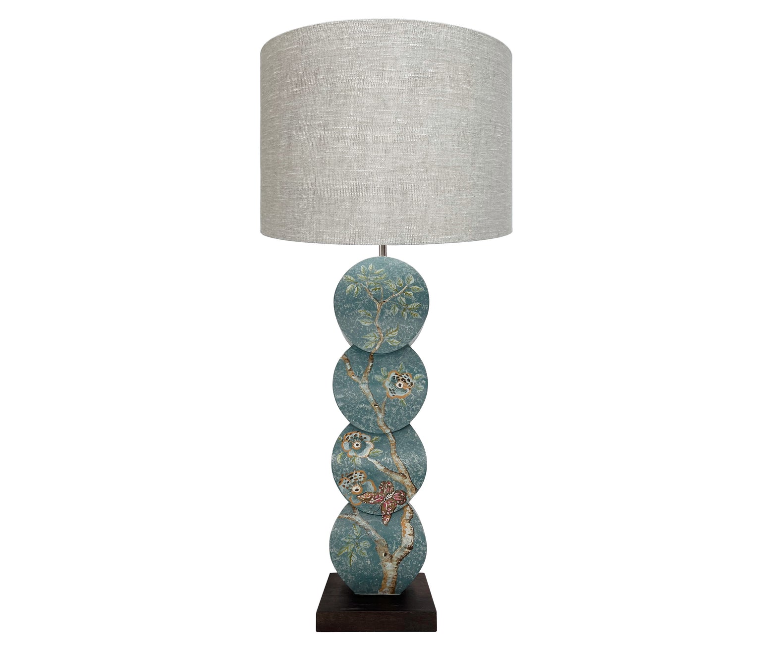 Front view of papillon lamp showing delightful silvery willow trees dance with blooming powder pink roses and burnt orange butterflies against chalky teal skies. 