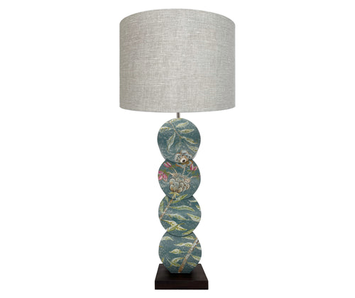 Front view of papillon lamp showing delightful silvery willow trees dance with blooming powder pink roses and burnt orange butterflies against chalky teal skies. 