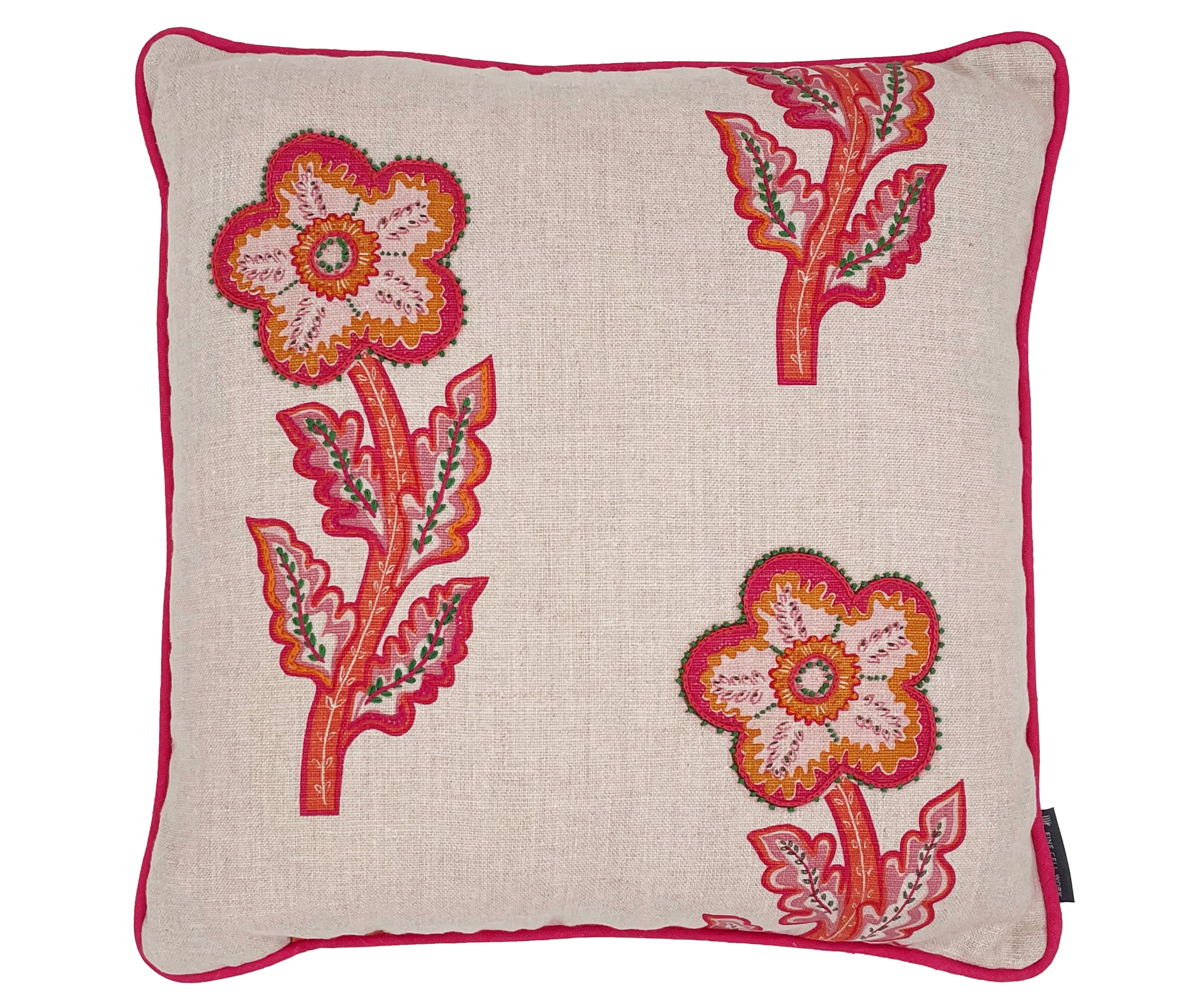 Detailed close up up of this a large 50x50 cushion with its natural linen base cloth is printed with a large daisy like floral design in bright pinks and oranges, and embellished with hand embroidered details, like chainstitch, and French knots, in green to add texture, with bright pink piping.