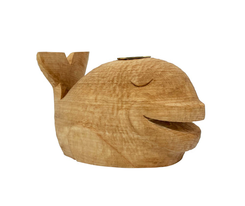 This hand carved beech whale candlestick is viewed facing the right.