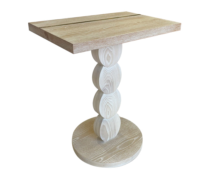 This small light oak table has a rectangular table top inlaid with a traditional brass ruler, on top of a base of 4 intersecting wooden discs, on a round oak base, viewed from the side. (viewed from above).