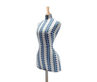 Side on view of the diamond stripe mannequin is covered in a blue and white fabric, with vertical stripes made up of horizontal blue diamonds, and over-stitched with blue cross-stitch detailing running vertically on the ecru linen ground of this mannequin, with pale wood finished stand and topper.