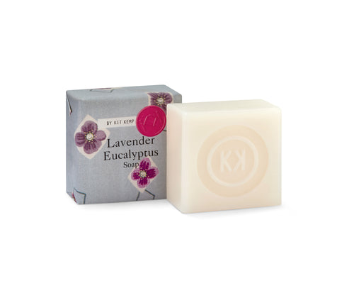 2, 50g lavender soaps, shown , on wrapped in the friendly flowers printed paper , with one outside of wrapping showing the natural soap bar embossed with the Kit Kemp logo.