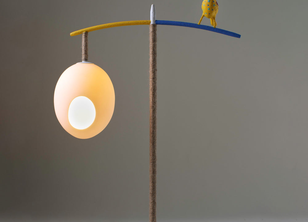 Our Sunny Robin Floor Lamp, stands 1.47m high and features two suspended eggs, counter balanced on a branch-like frame, softened with organic twine, with a beautifully crafted funky robin, standing proudly between the nest-like eggs, in white, with monochrome, red and natural twine finish