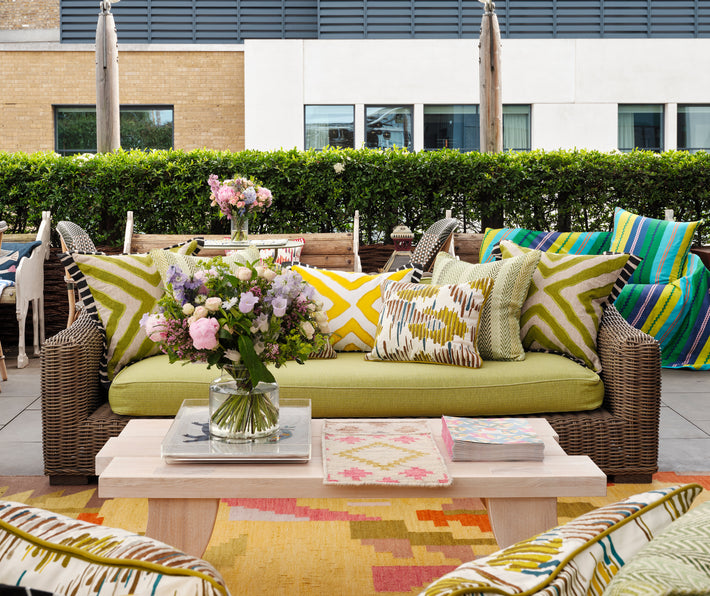 Shades of green and yellow cushions on sofa