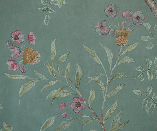 Detailed shot of the Kit's New Songbird Wallpaper in the Rain colourway is suffused in the blue/ green of an english rainy day, where a breeze ruffles the leaves of loosely painted trees dotted with dog roses.