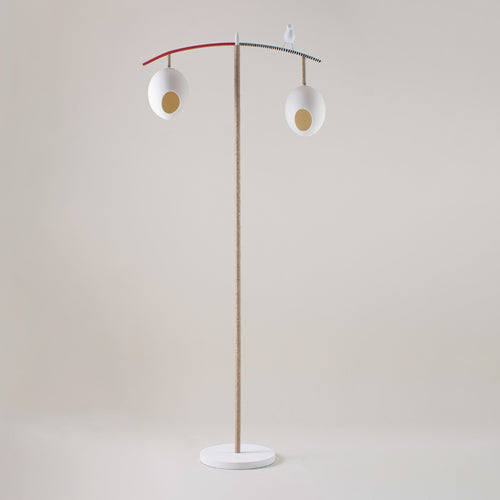 Our Sunny Robin Floor Lamp, stands 1.47m high and features two suspended eggs, counter balanced on a branch-like frame, softened with organic twine, with a beautifully crafted funky robin, standing proudly between the nest-like eggs, in white, with monochrome, red and natural twine finish. Made in collaboration with Porta Romana