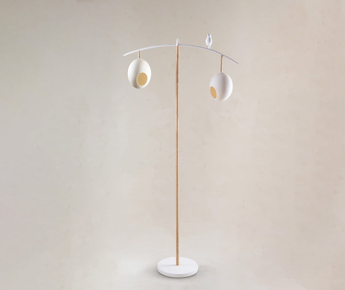 Our Sunny Robin Floor Lamp, stands 1.47m high and features two suspended eggs, counter balanced on a branch-like frame, softened with organic twine, with a beautifully crafted funky robin, standing proudly between the nest-like eggs, in white, with monochrome, red and natural twine finish