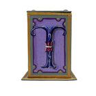 This grey and lilac alphabet box is decorated with a blue letter T in a heraldic decorative style, surrounded by a lilac starred sky, and embellished with a jewelled lid. 