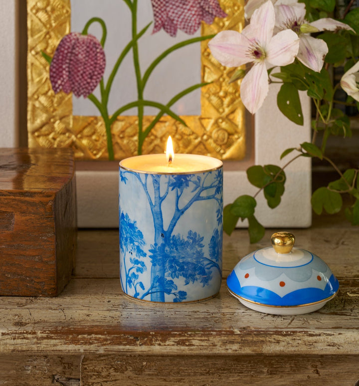 Kit Kemp Tall Trees blue and white ceramic candle with a floral pattern and a gold lid.