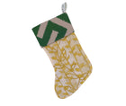 Kit's Yellow Tea leaves Fabric ( featuring vertical branch like stems with small yellow leaves sprouting from each side, on a natural ground, is used here to make a Christmas stocking with bold wide dark green zig zag, on natural linen contrasting fabri