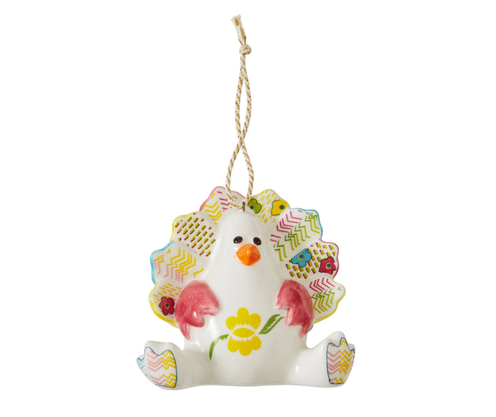 The Timothy Turkey seated Turkey white china ornament is inspired by Kit Kemp's patchwork toys and is decorated in bright pastel shades, with floral, and stripe designs on it's tail feathers and feet.