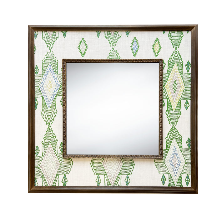 The Travelling Light Mirror, features Kit Kemp's fabric designed for Christopher Farr , in white linen, and draws its design inspiration from traditional kilim designs, in shades of fresh greens and blues, stretched to form a wide decorative border around a square central mirror, in a wooden frame, to stunning effect.