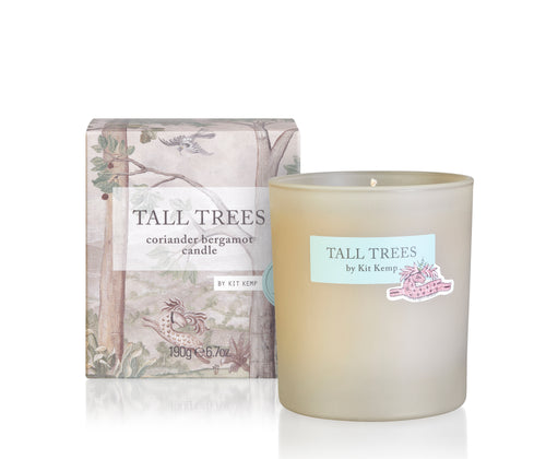 A round scented coriander bergamot candle in a glass frosted vessel and a packaging box with tall trees design applied