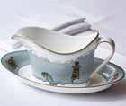 Kit Kemp for Wedgwood. Sailor's Farewell sauce boat and stand crafted in fine bone china features several motifs. The design is embellished with a deeper blue and hand-applied 22 carat gold trim