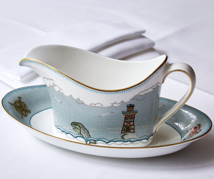 Kit Kemp for Wedgwood. Sailor's Farewell sauce boat and stand crafted in fine bone china features several motifs. The design is embellished with a deeper blue and hand-applied 22 carat gold trim