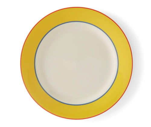 The Yellow Calypso Dinner plate, is a large 27cm white plate, with a wide yellow band, bordered by narrow central stripes in pink and blue, and tipped with a pink outer band. Sold in sets of 4, these plates bring joy and sunshine to your table settings.